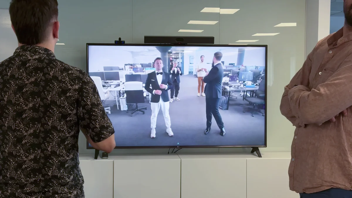 B2B use case: corporate event audience watching the AI virtual try-on with avatars in tuxedos
